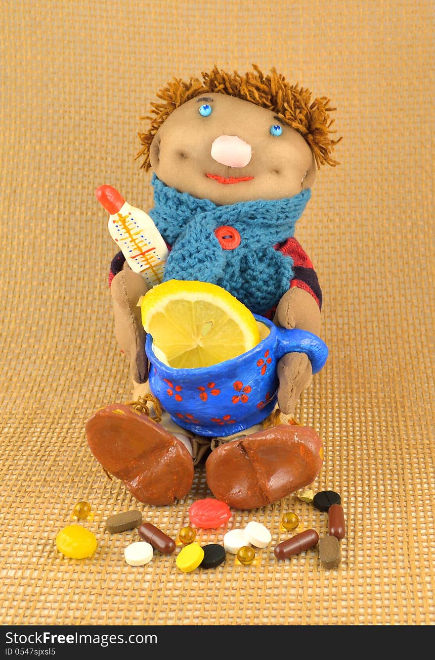 Handmade toy with pills, cup of tea and slice of lemon. Handmade toy with pills, cup of tea and slice of lemon