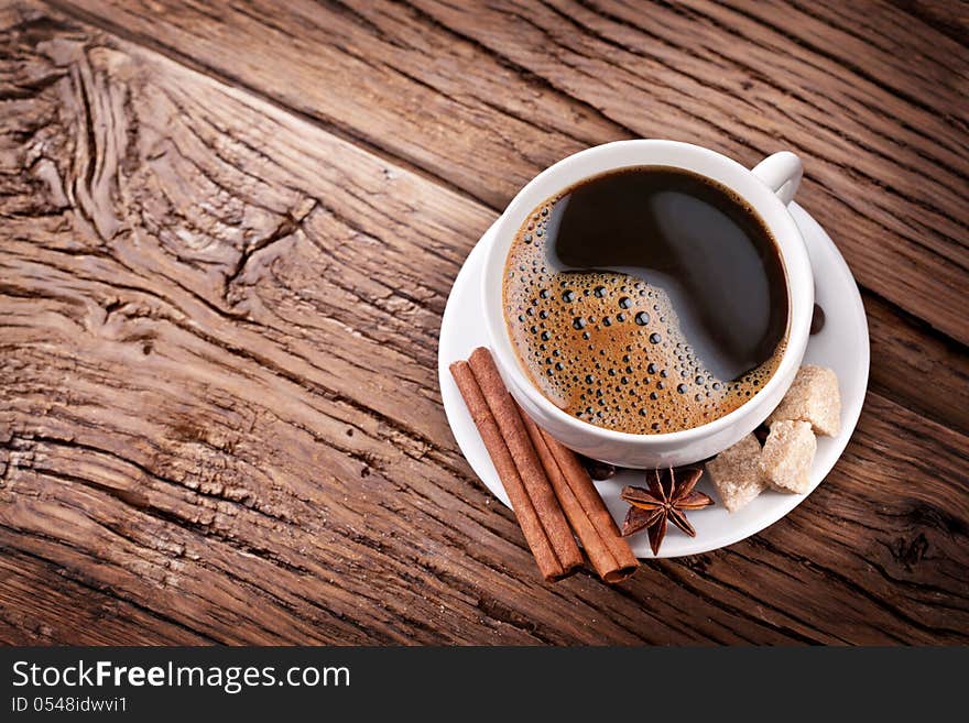 Cup of coffee with brown sugar on a wooden table. Cup of coffee with brown sugar on a wooden table.