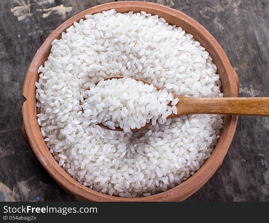 Rice on bowl and wooden spoon