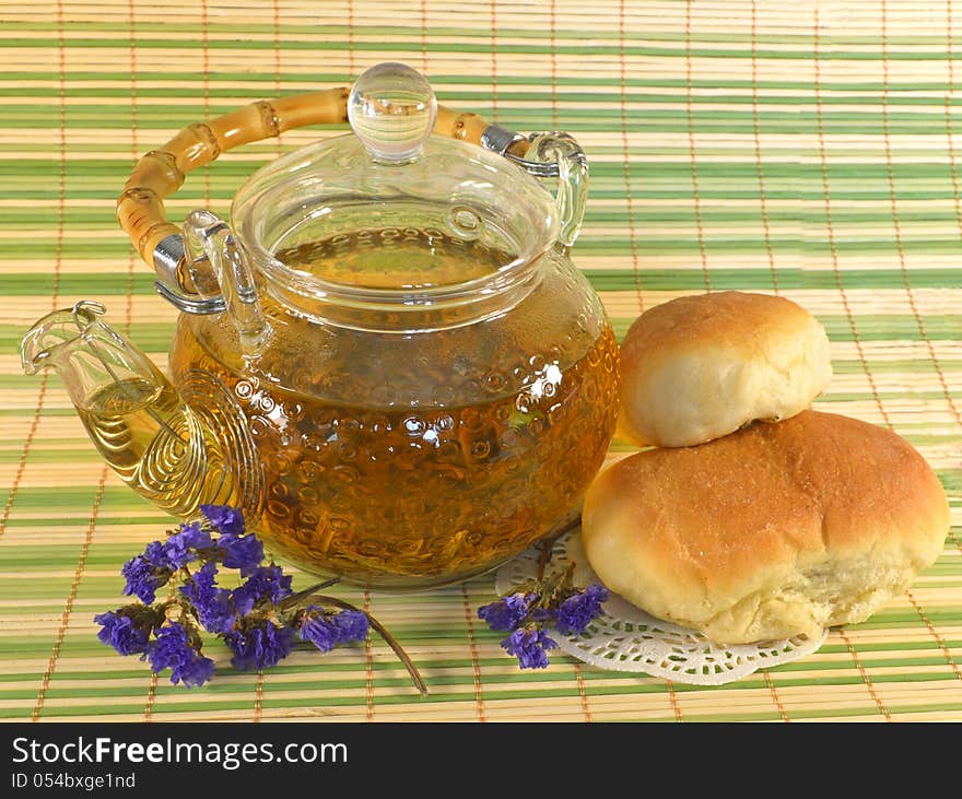 Teapot with buns and flowers