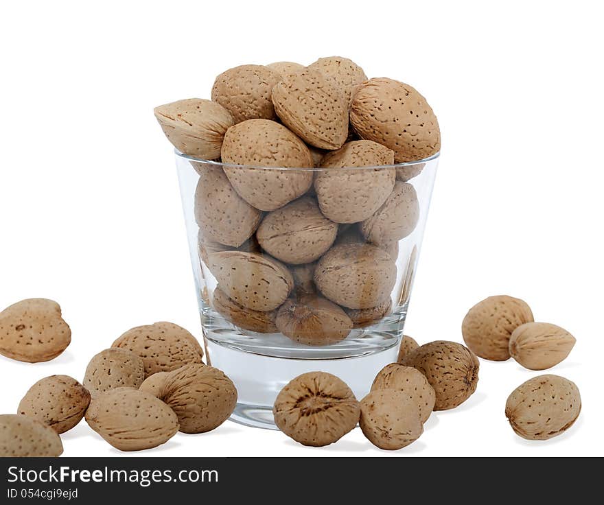 Cup with almonds on white background