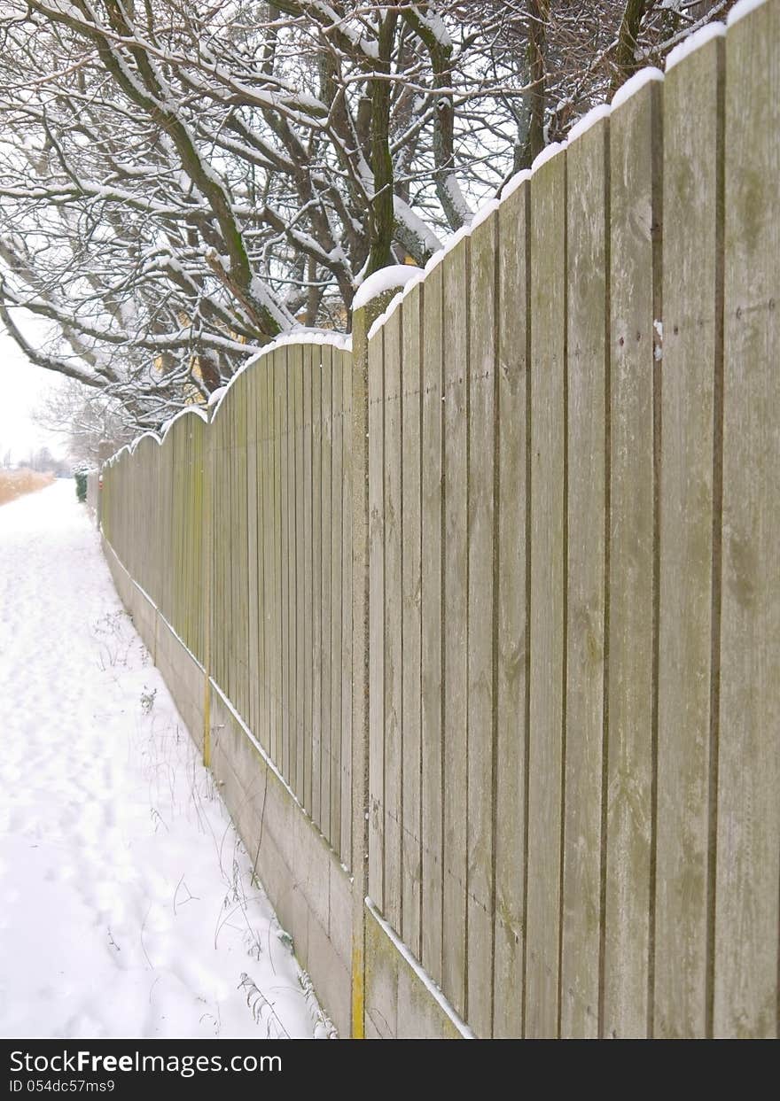 A fence covered with snow. A fence covered with snow.