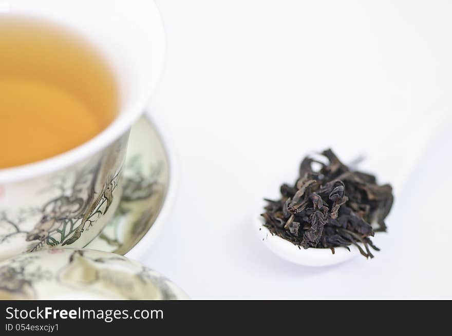 Cup Of Chinese Tea With Dry Tea Leaves  On White Background