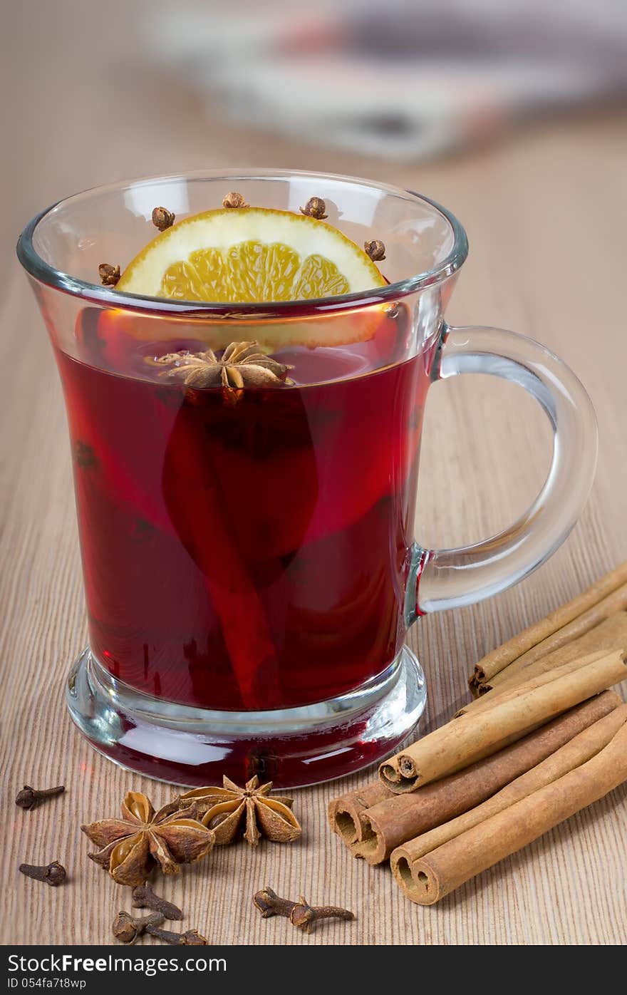 Fragrant mulled wine flavored with spices in a glass of orange.