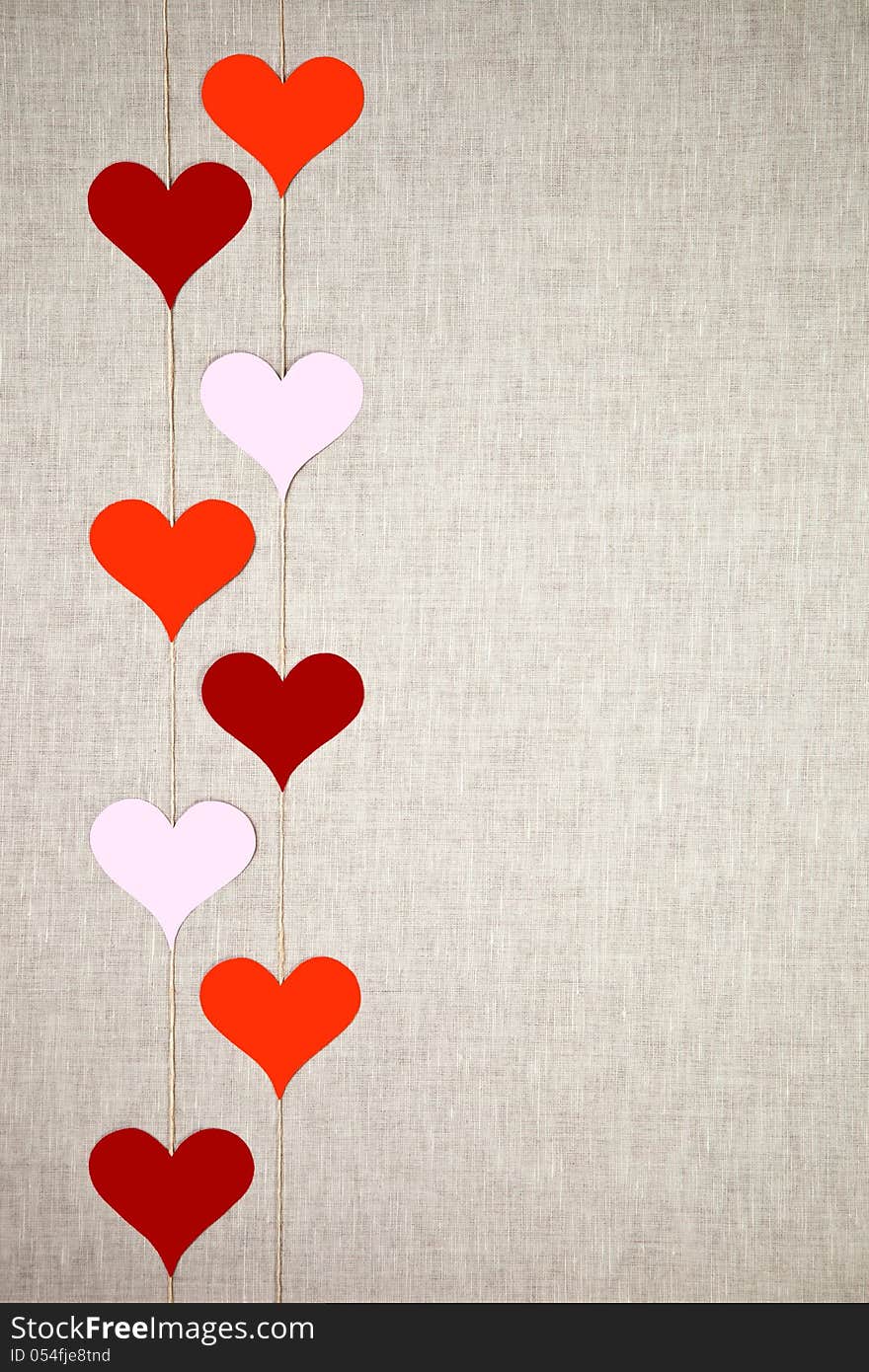 Hearts garlands on linen background