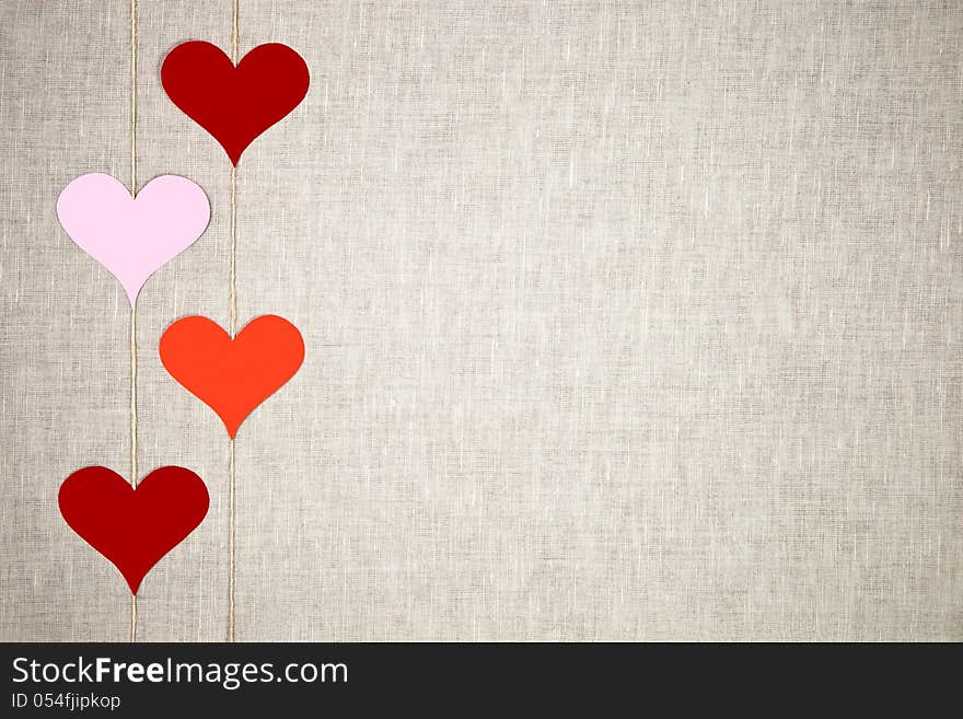 Hearts garlands on linen background