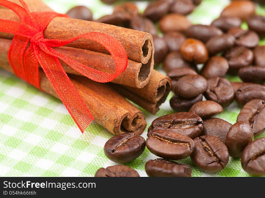 Cinnamon sticks with red ribbon and coffee beans. Cinnamon sticks with red ribbon and coffee beans