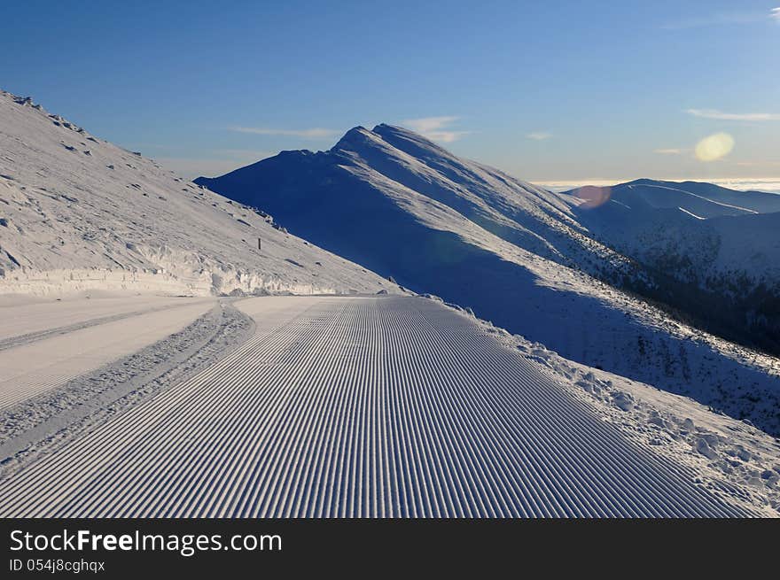 Extensive ski piste and powder snow off piste Snow grooming machine tracks - Slovac ski resort - Jasna