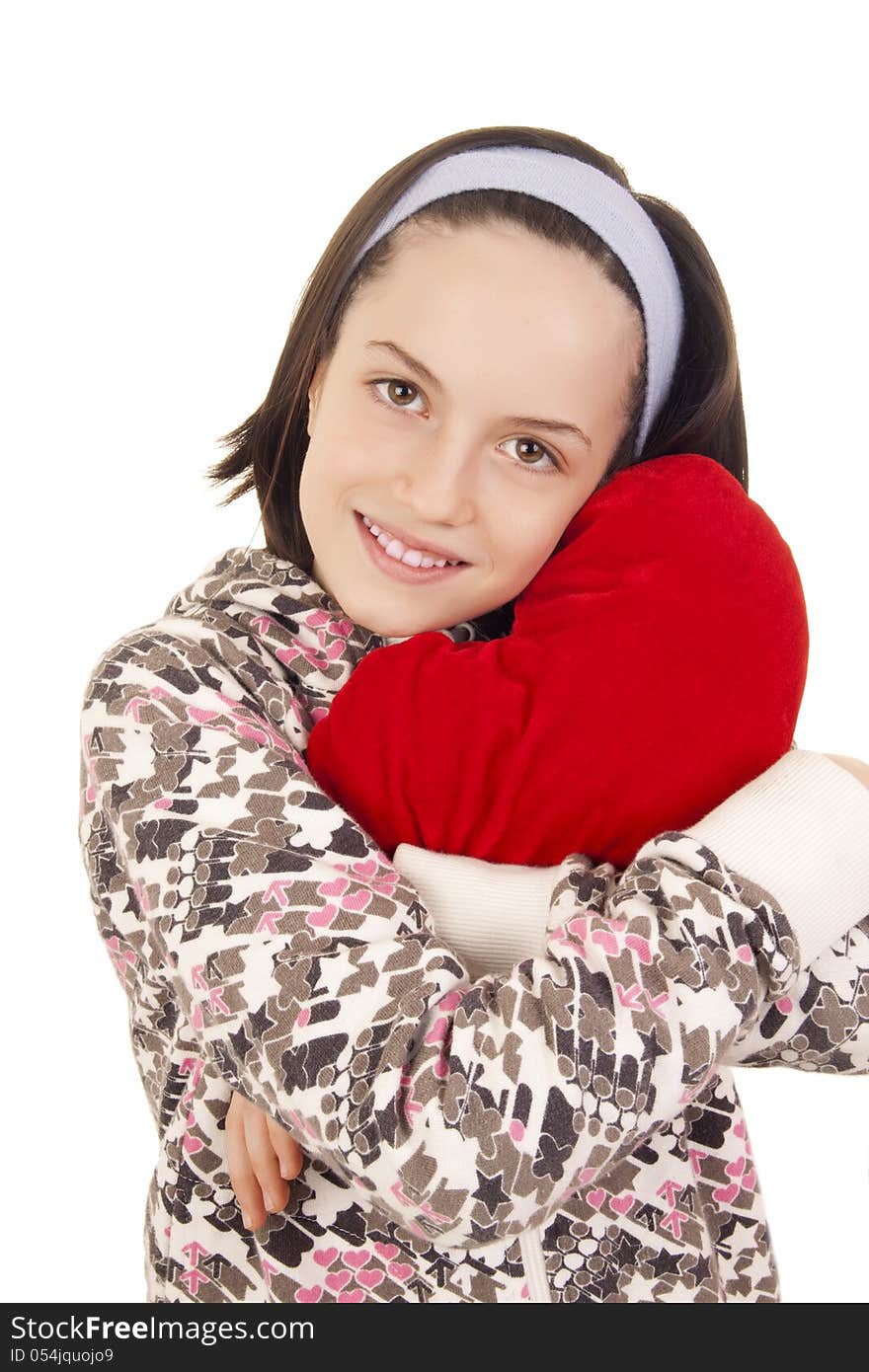 Beautiful young girl hugging heart shape pillow