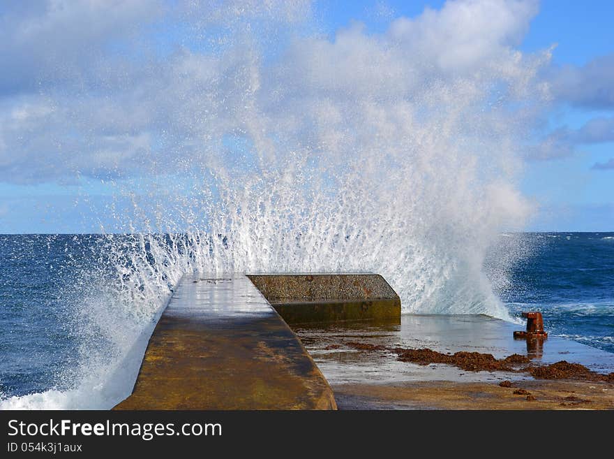 Sea waves hitting the pier big surf. Sea waves hitting the pier big surf