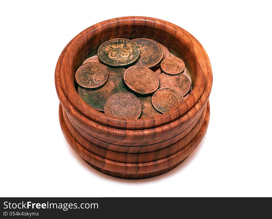 Ancient, unique coins in wooden pot isolated on white background. Ancient, unique coins in wooden pot isolated on white background