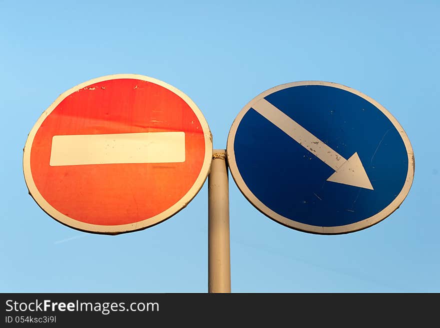 Two Signs on Blue Background