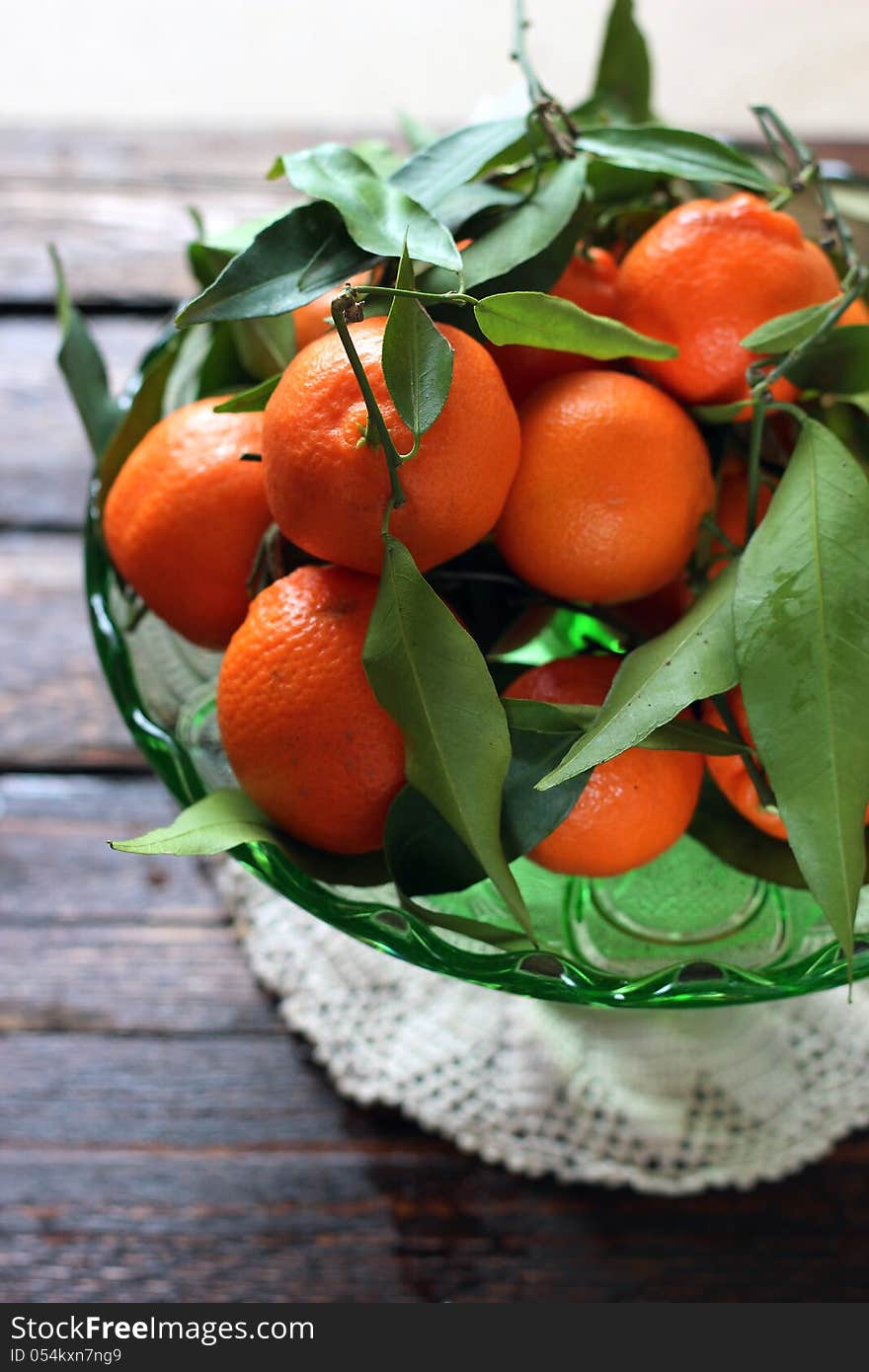 Bowl of fresh mandarins with leaves and branches. Bowl of fresh mandarins with leaves and branches