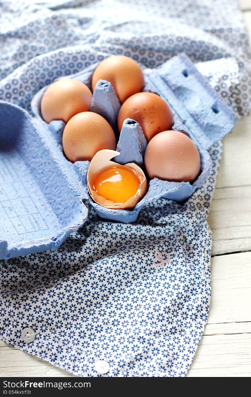 Blue box full with eggs on a white blue background. Blue box full with eggs on a white blue background