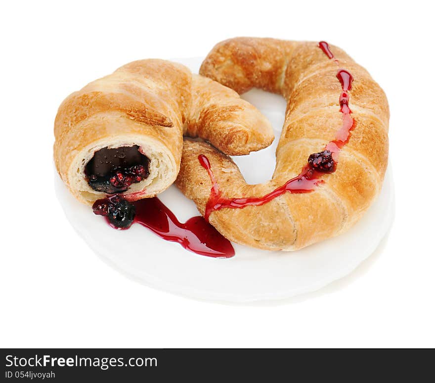 Croissant with chocolate and raspberry jam on plate