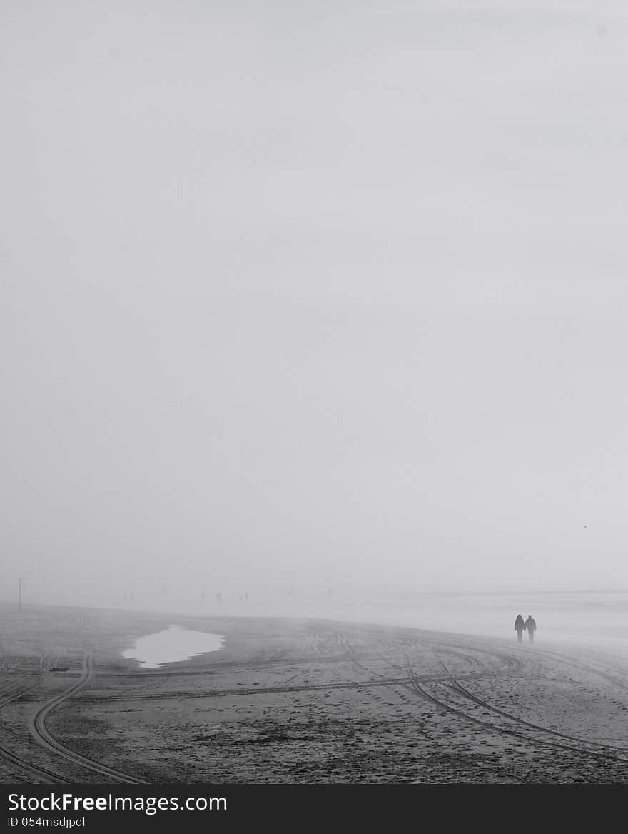 People on beach in the fog