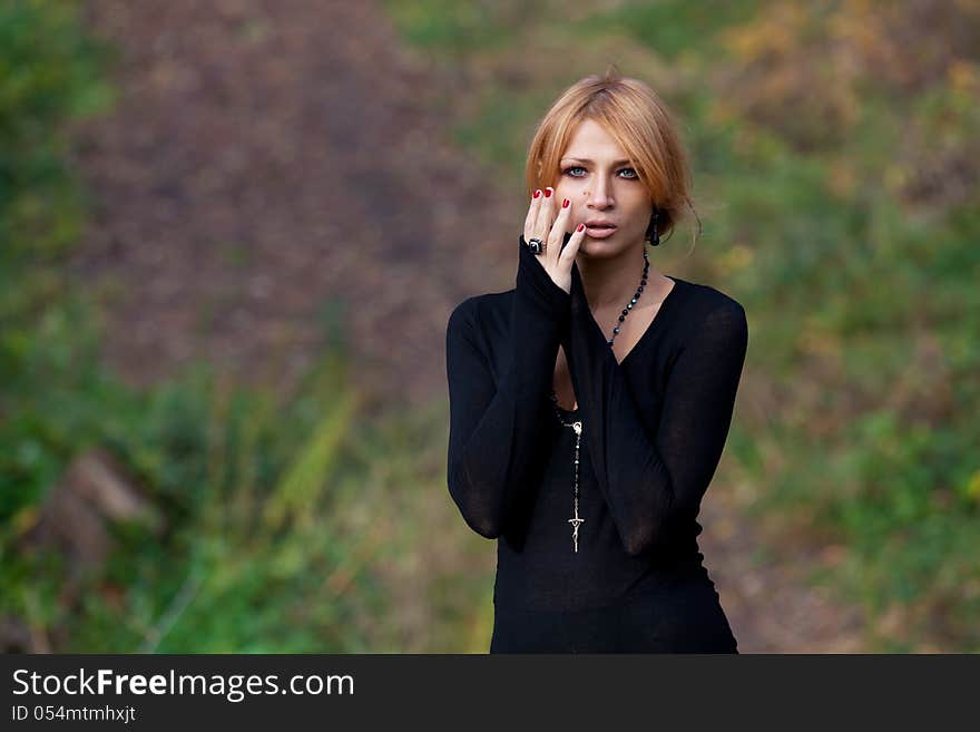 Beautiful mysterious girl in the autumn forest