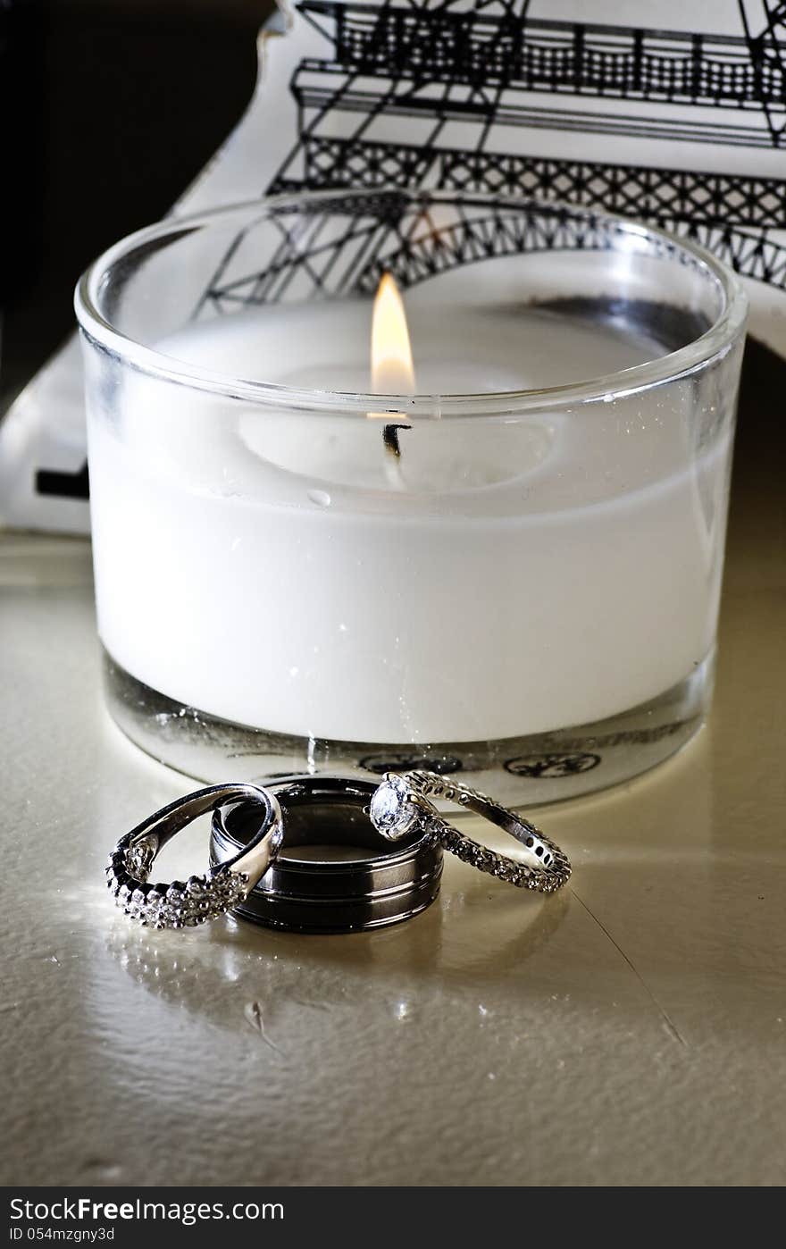 Vertical: Wedding Rings, White Candle, Table Decor
