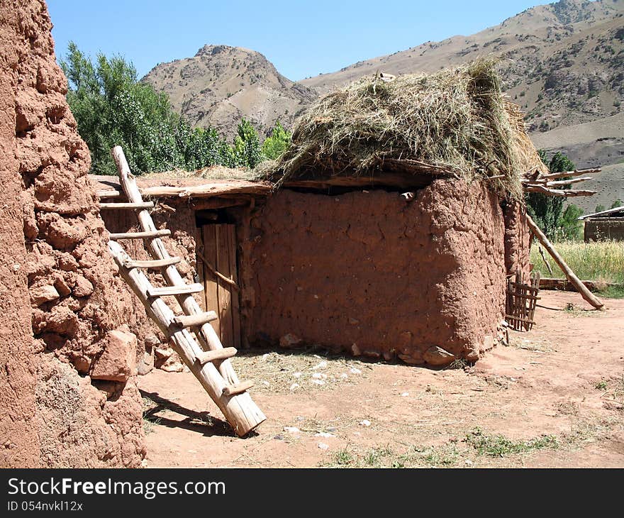 House of red clay located high in the mountains of Kyrgyzstan. House of red clay located high in the mountains of Kyrgyzstan