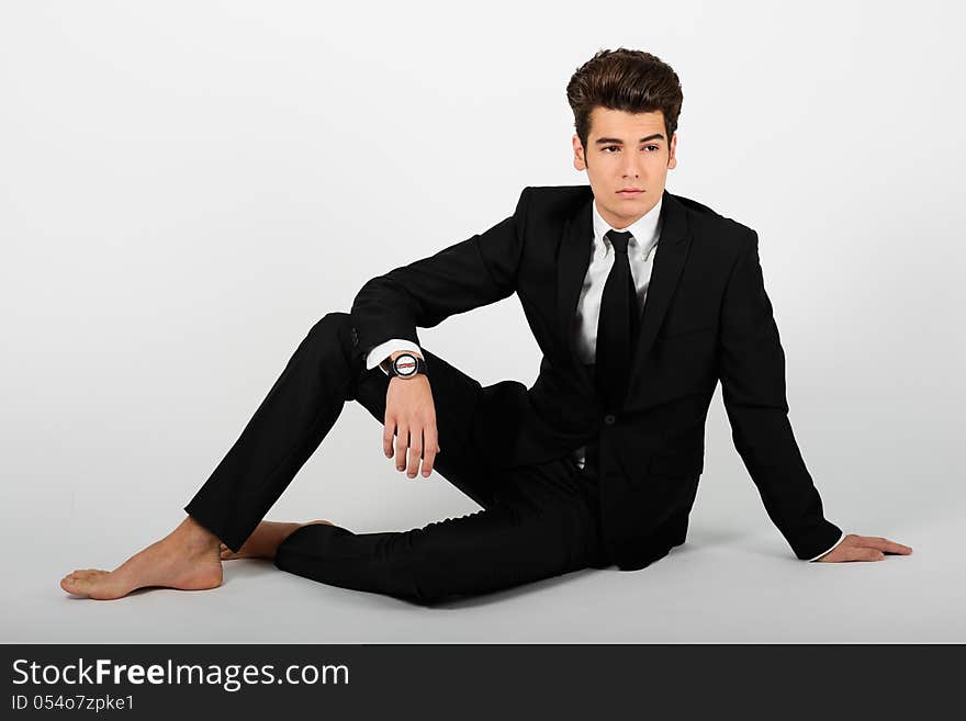 Young businessman barefoot,  on white background