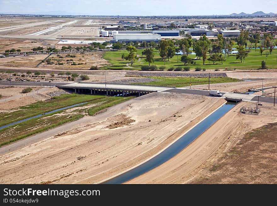 Road with bridge over wash and canal leading to airport. Road with bridge over wash and canal leading to airport