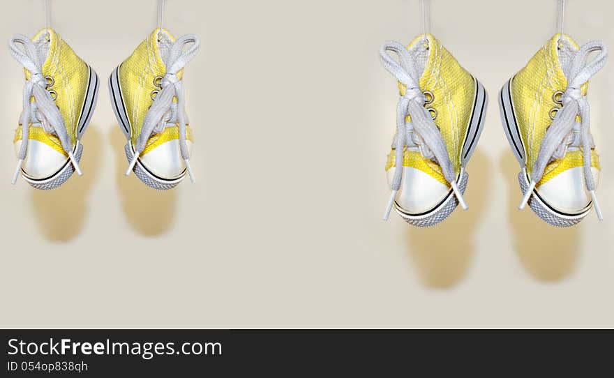 Hanged two pair of canvas shoes with  background. Hanged two pair of canvas shoes with  background