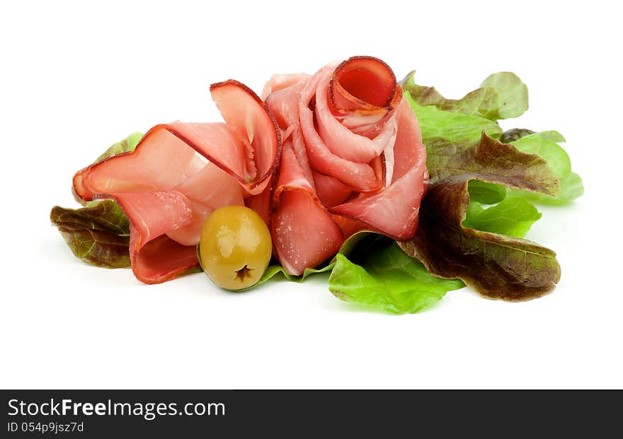 Curling Slices of Jamon on Lettuce Romano with Green Olive isolated on white background. Curling Slices of Jamon on Lettuce Romano with Green Olive isolated on white background