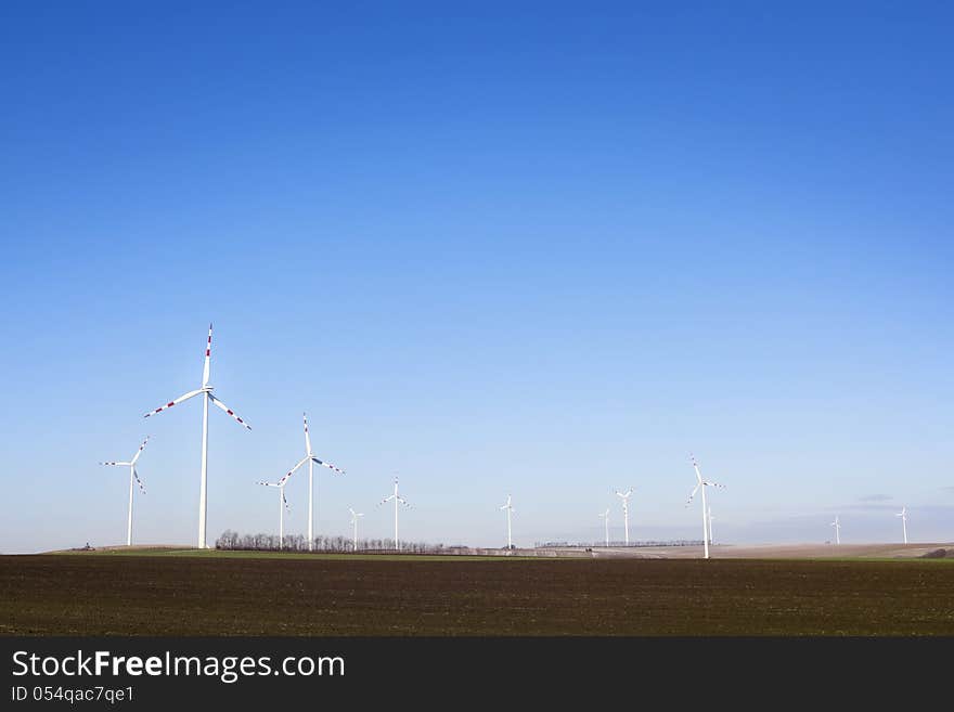 Power plant - wind farm - over clear blue sky