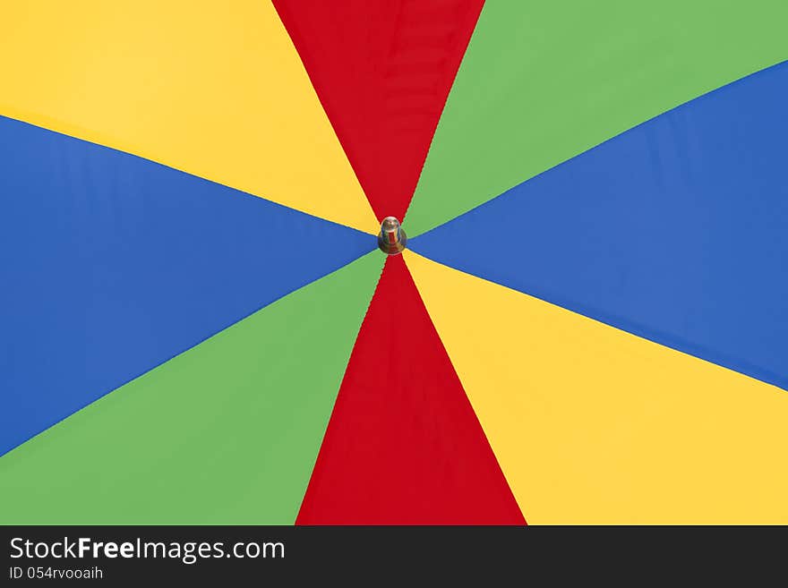 Very bright and bold colorful umbrella close up as a background. Very bright and bold colorful umbrella close up as a background.