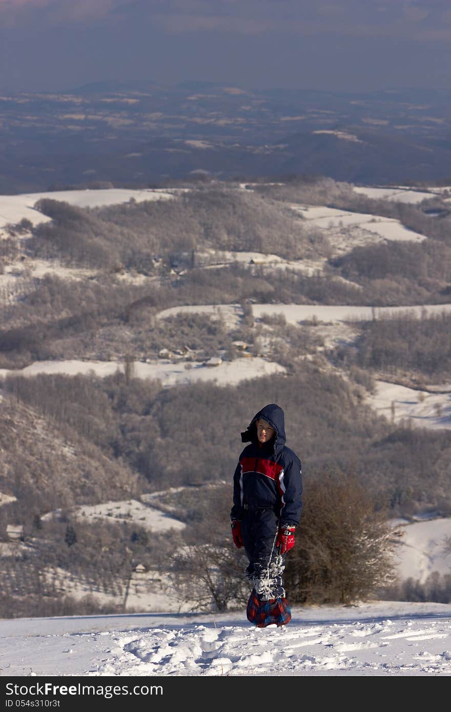 A boy on a snow-covered mountain