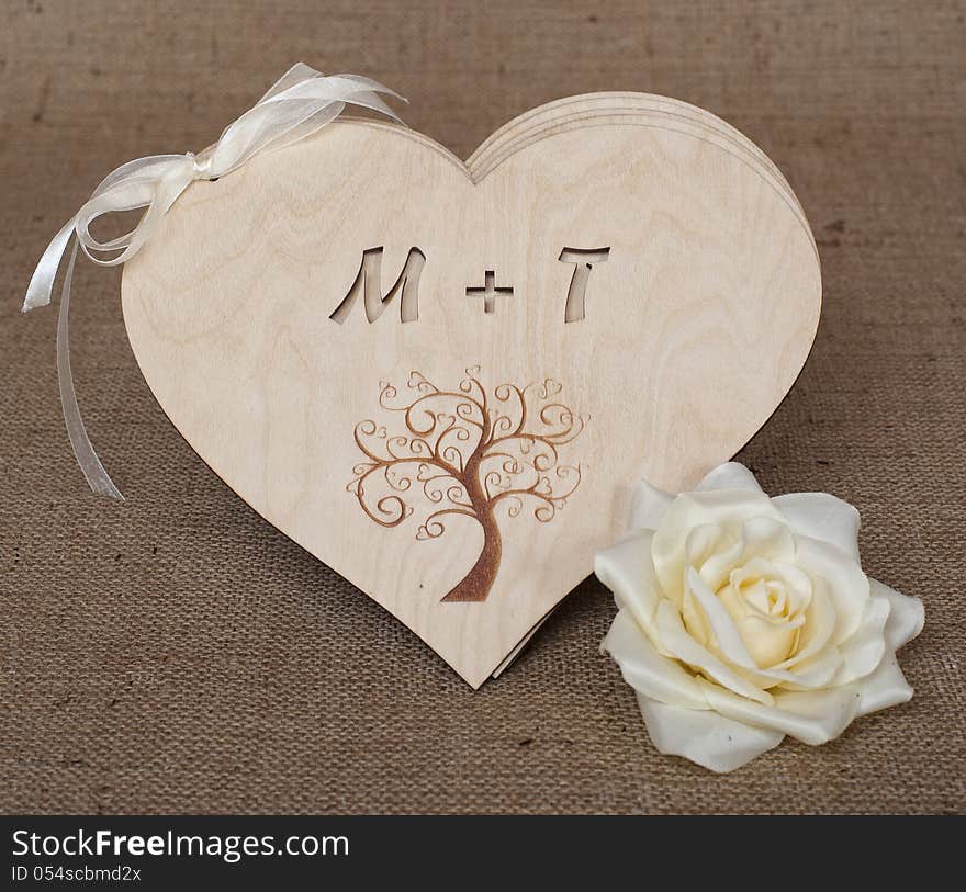 Wooden hearts with flower on natural burlap. Wooden hearts with flower on natural burlap