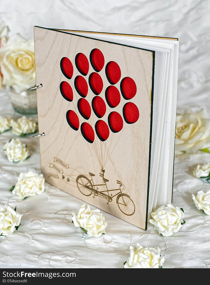 Wooden wedding guestbook with flowers in studio. Wooden wedding guestbook with flowers in studio