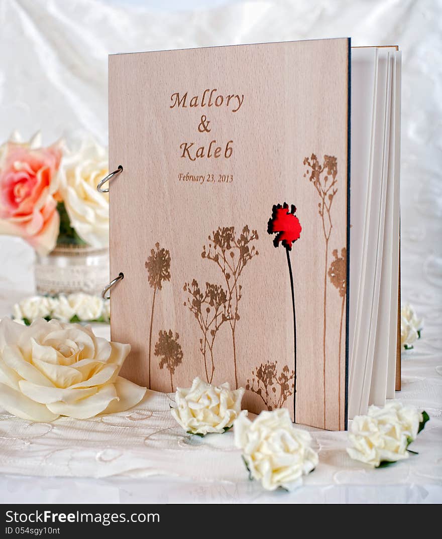 Wooden wedding guestbook with flowers in studio. Wooden wedding guestbook with flowers in studio