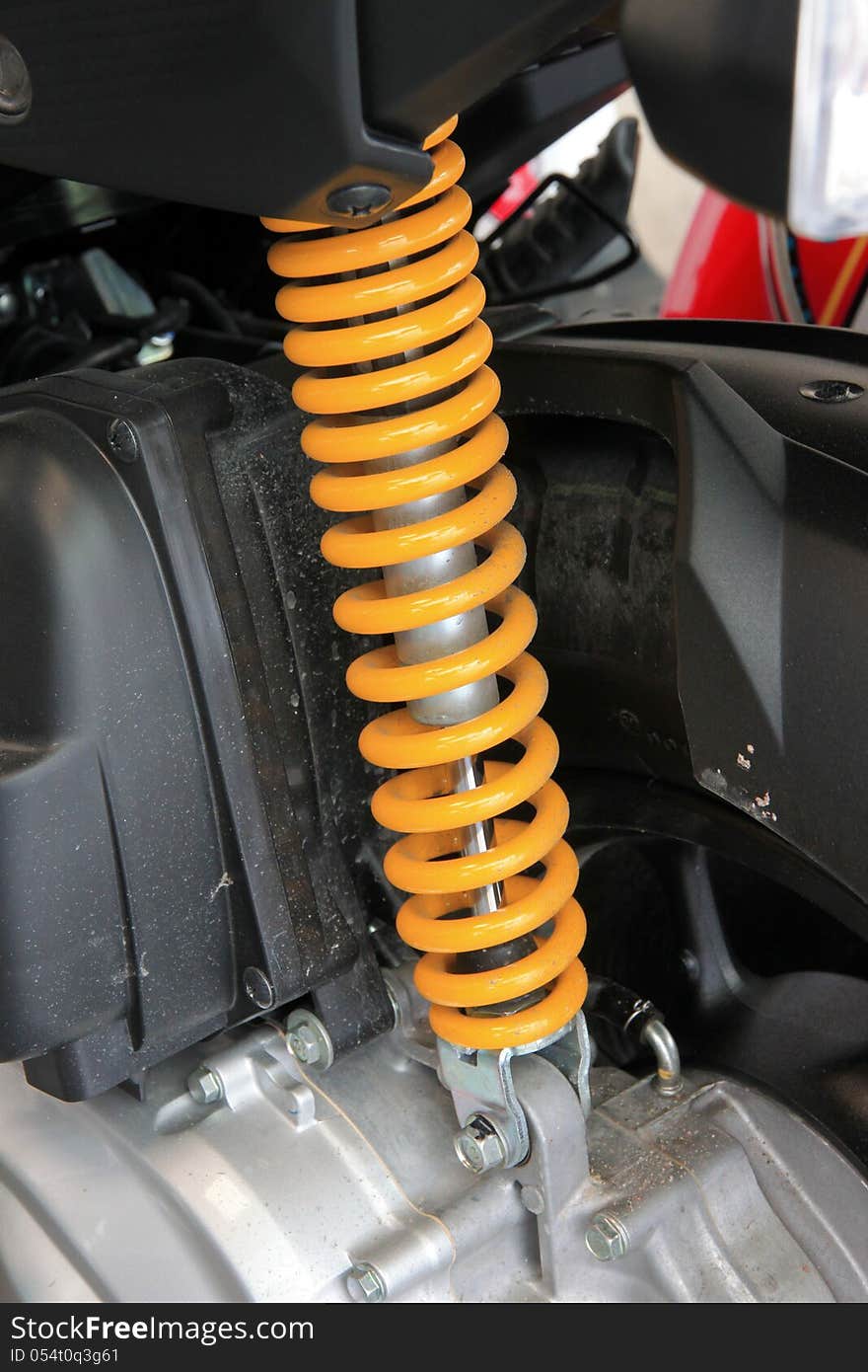 Yellow Shock Absorber. It is the motocycle.