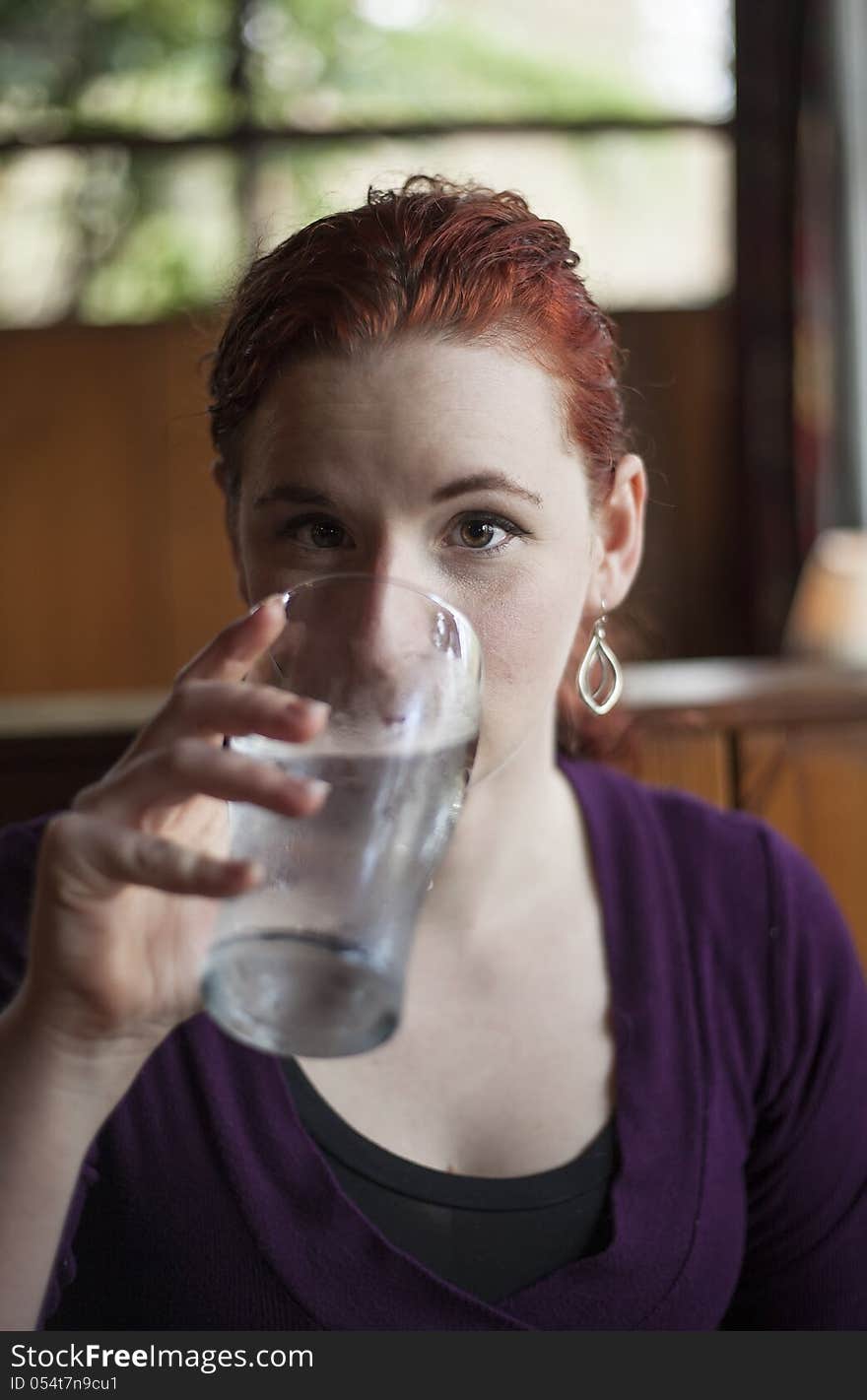 Young Woman With Beautiful Auburn Hair Drinking Water