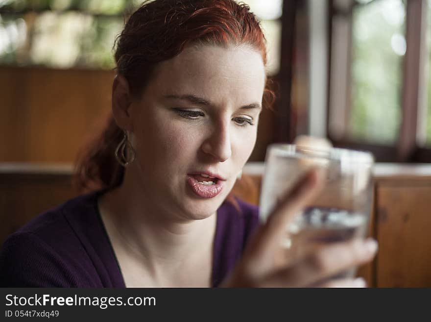 Young Woman With Beautiful Auburn Hair Drinking Water