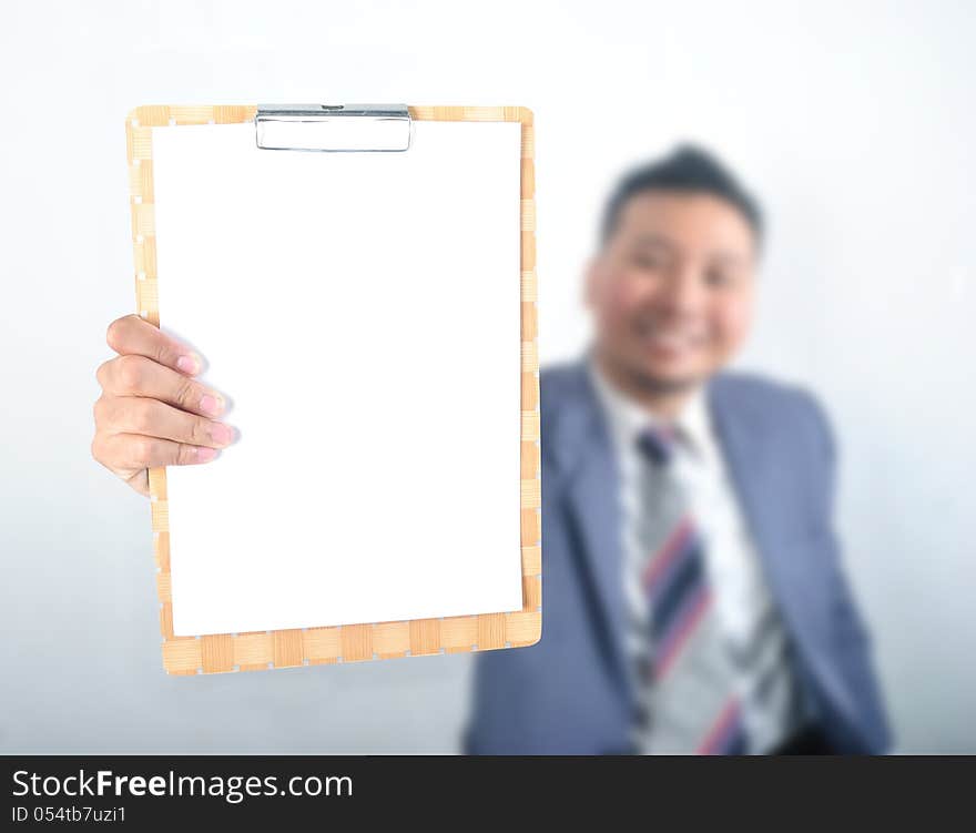 Business man showing note pad with blank paper