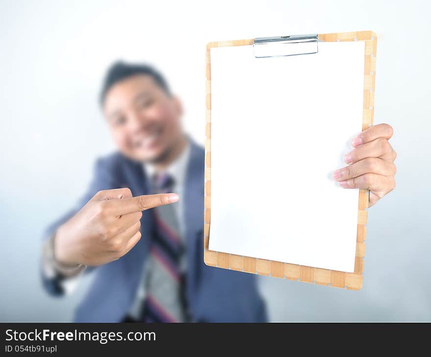 Business man showing note pad with blank paper