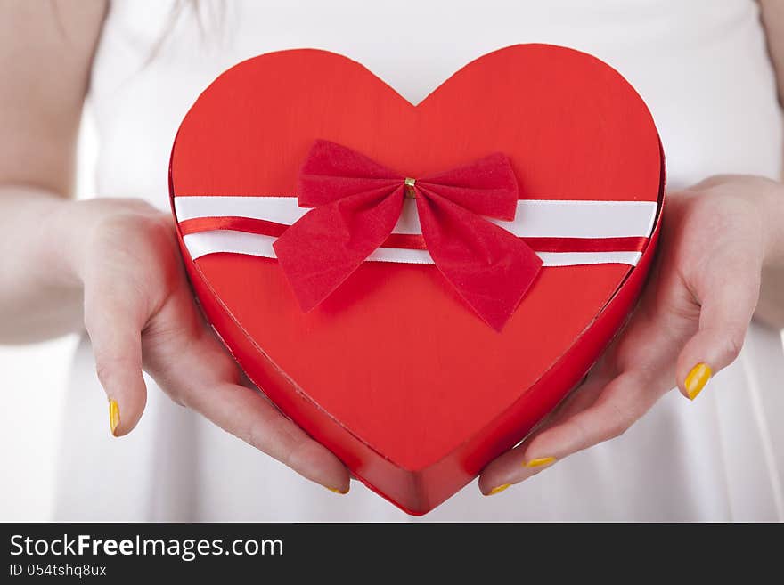 A heart shape in a girls hands