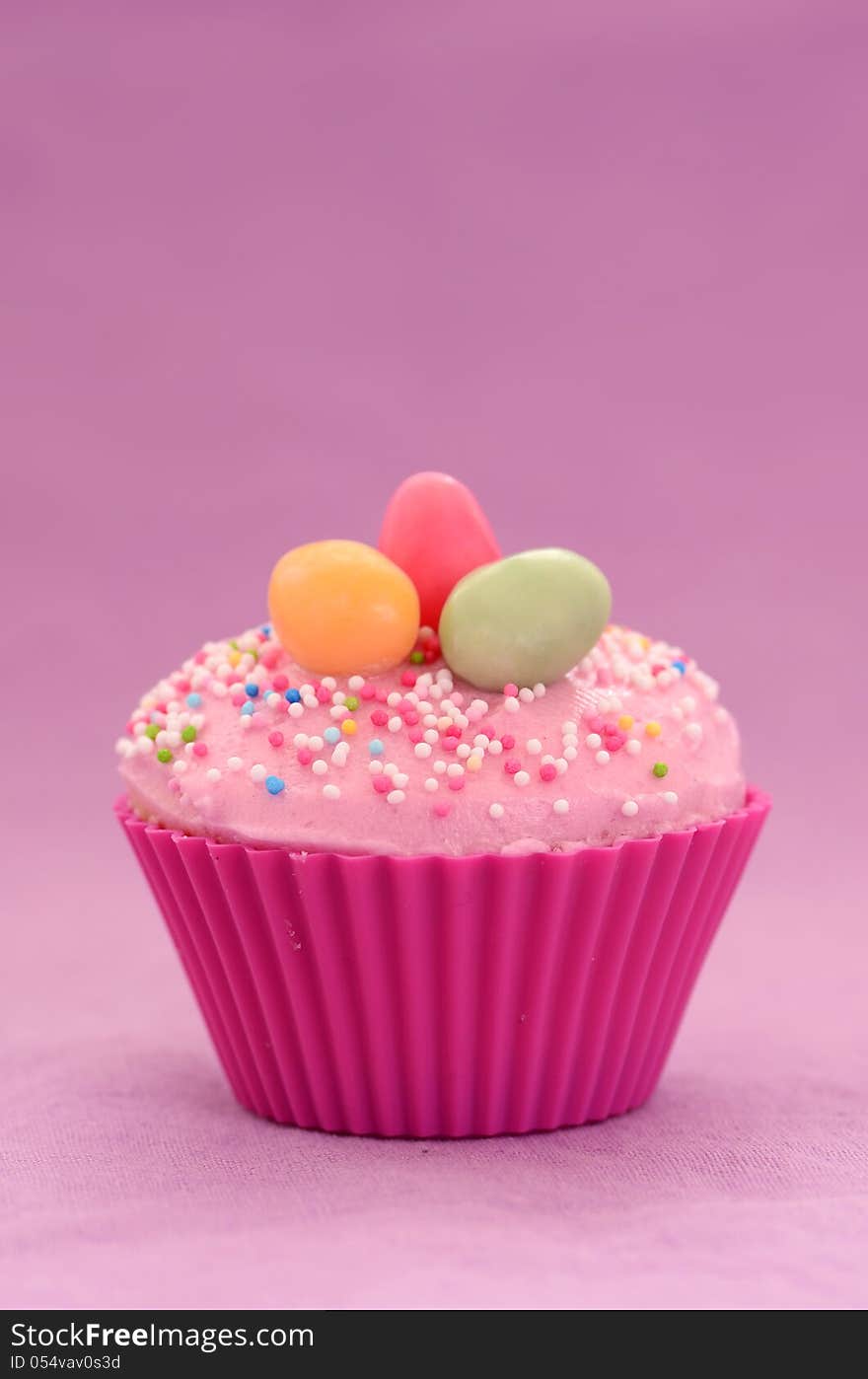 Easter cupcake on purple background with copy space