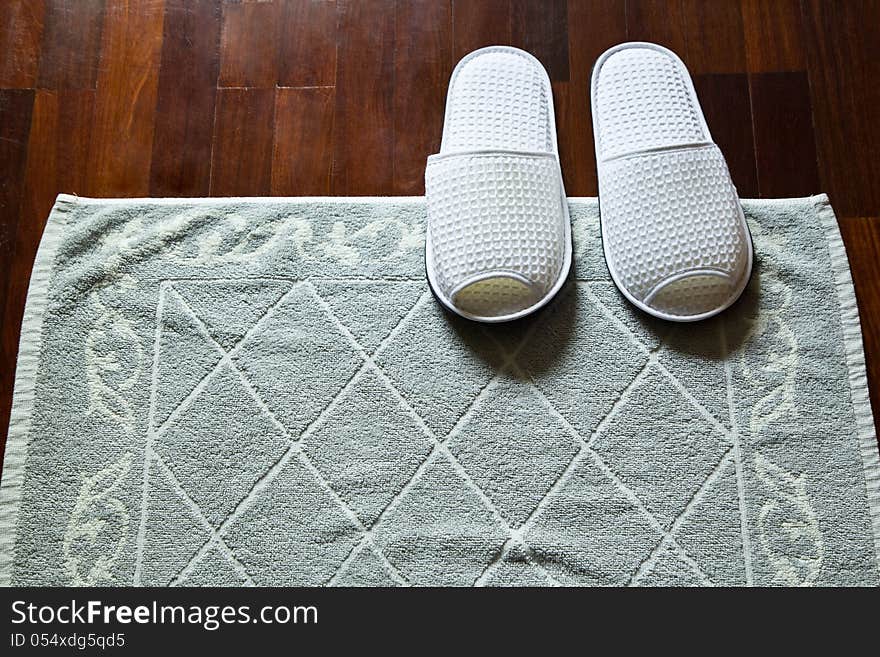 White slippers and doormat