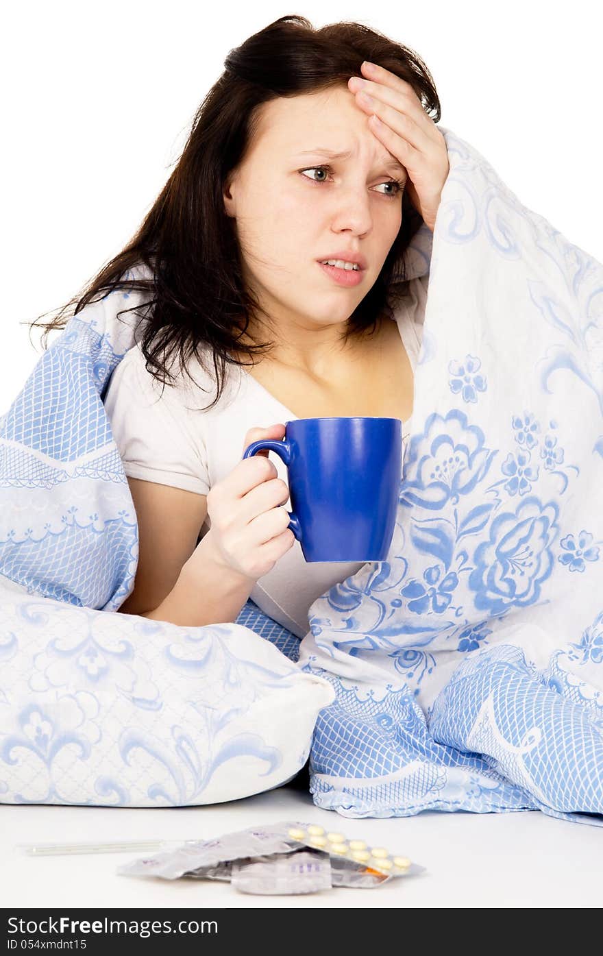 The diseased girl lying on the bed, and drink medicine on white background