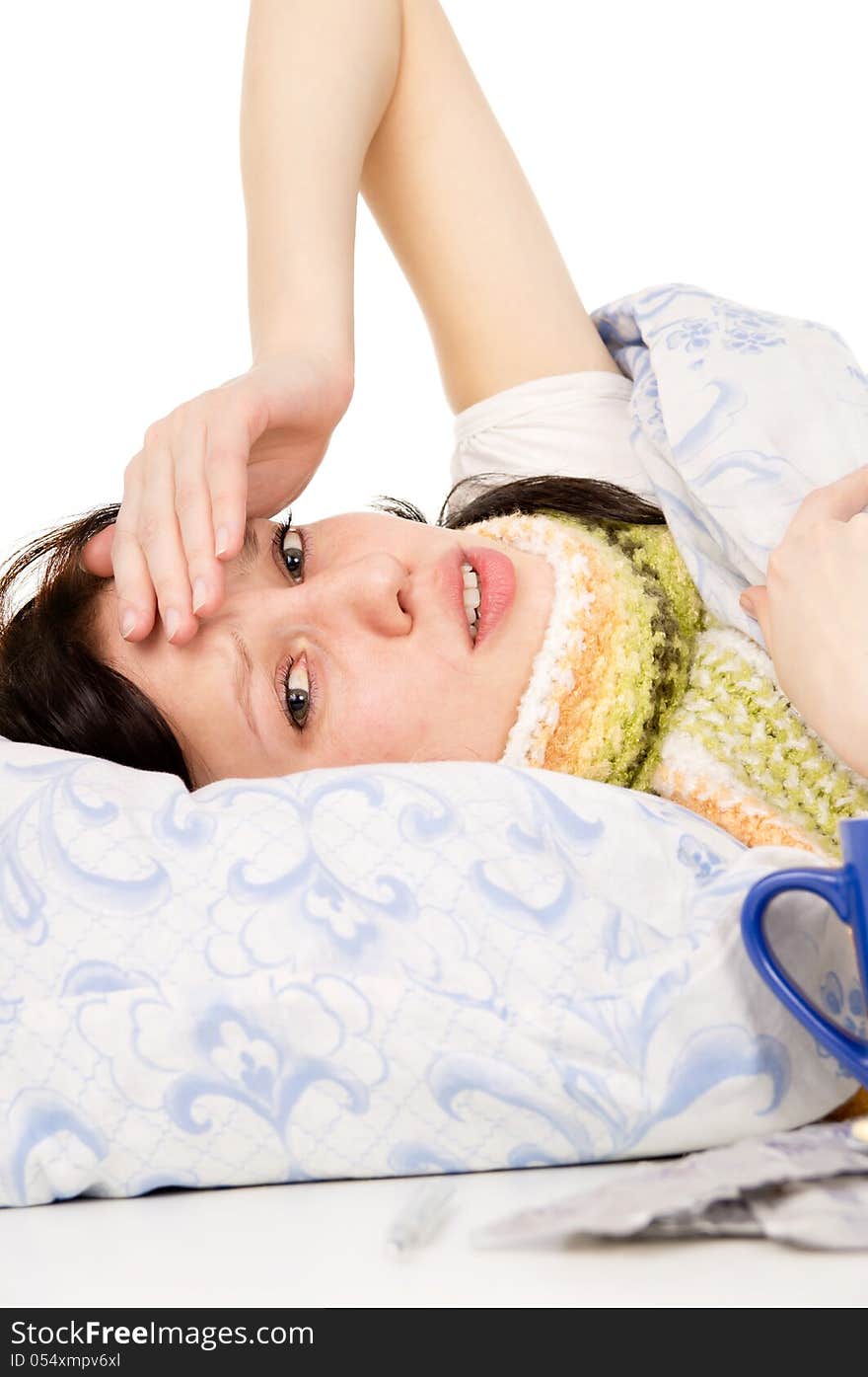 The diseased beautiful girl lying in bed, aching head isolated on white background