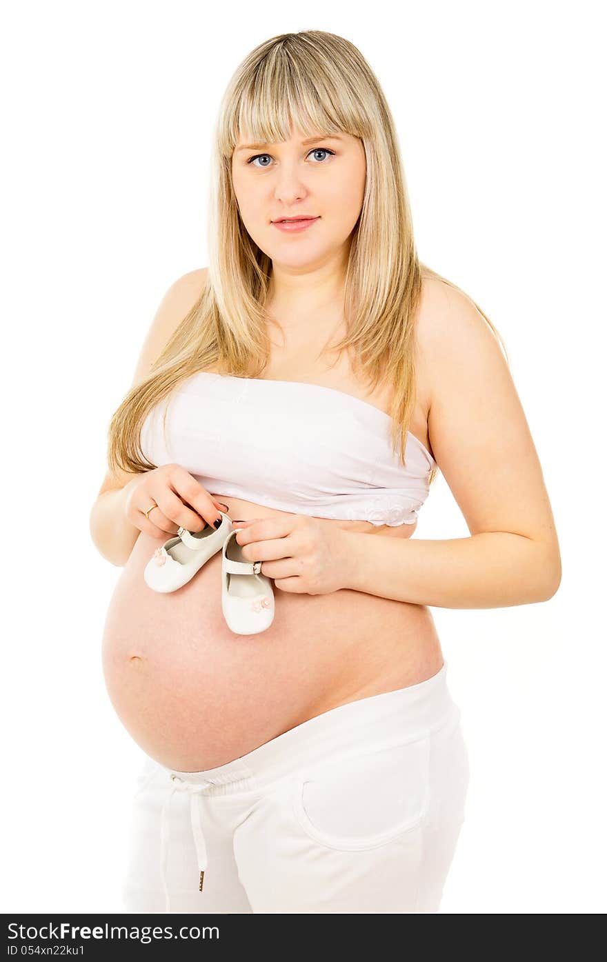 Pregnant girl with baby shoes. Pregnant girl with baby shoes