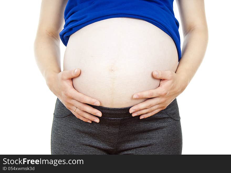 Detail of pregnant woman touching her abdomen