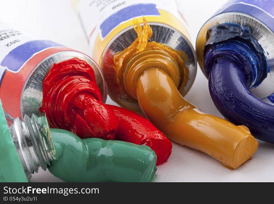 Oil paint of four colors squeezed out from the tube