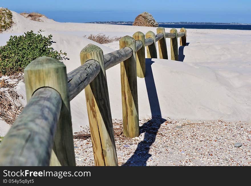 Landscape with wooden poles in white beach sand. Landscape with wooden poles in white beach sand