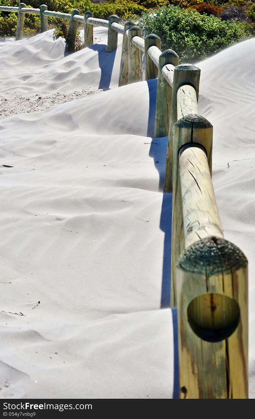 Landscape with wooden poles in white beach sand. Landscape with wooden poles in white beach sand