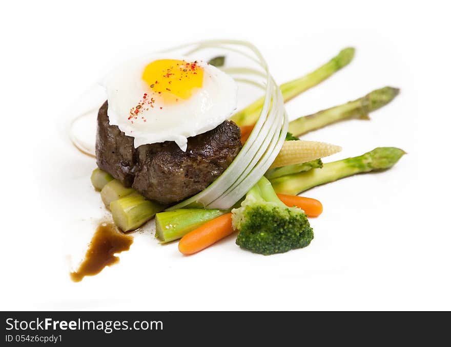 Meat steak fried egg top, variety garnish vegetables. Meat steak fried egg top, variety garnish vegetables