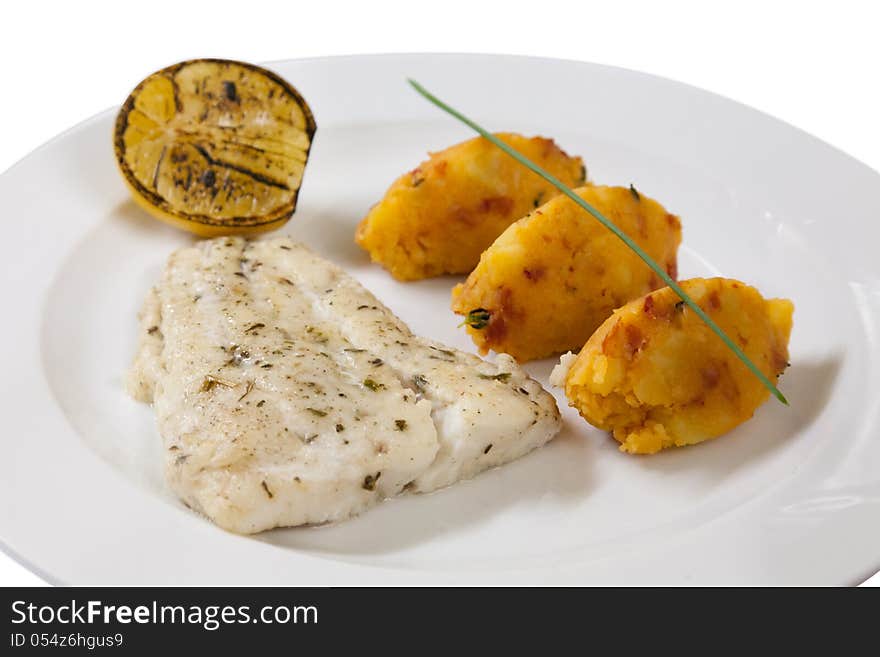 Fish fillet with potato cutlets on a white plate. Fish fillet with potato cutlets on a white plate